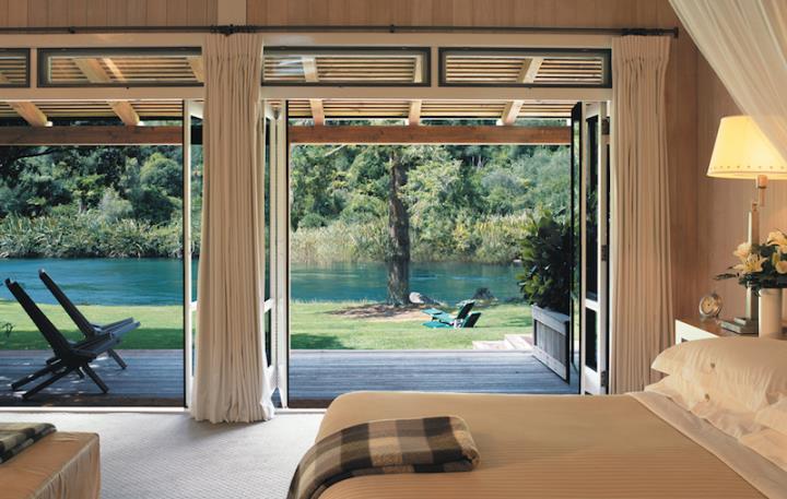 Suite interior at Huka Lodge New Zealand overlooking a garden and river
